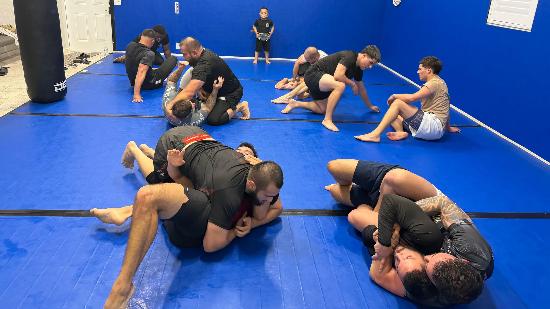 Students rolling during an open mat Brazilian Jiu-Jitsu training session in Fort Myers, FL